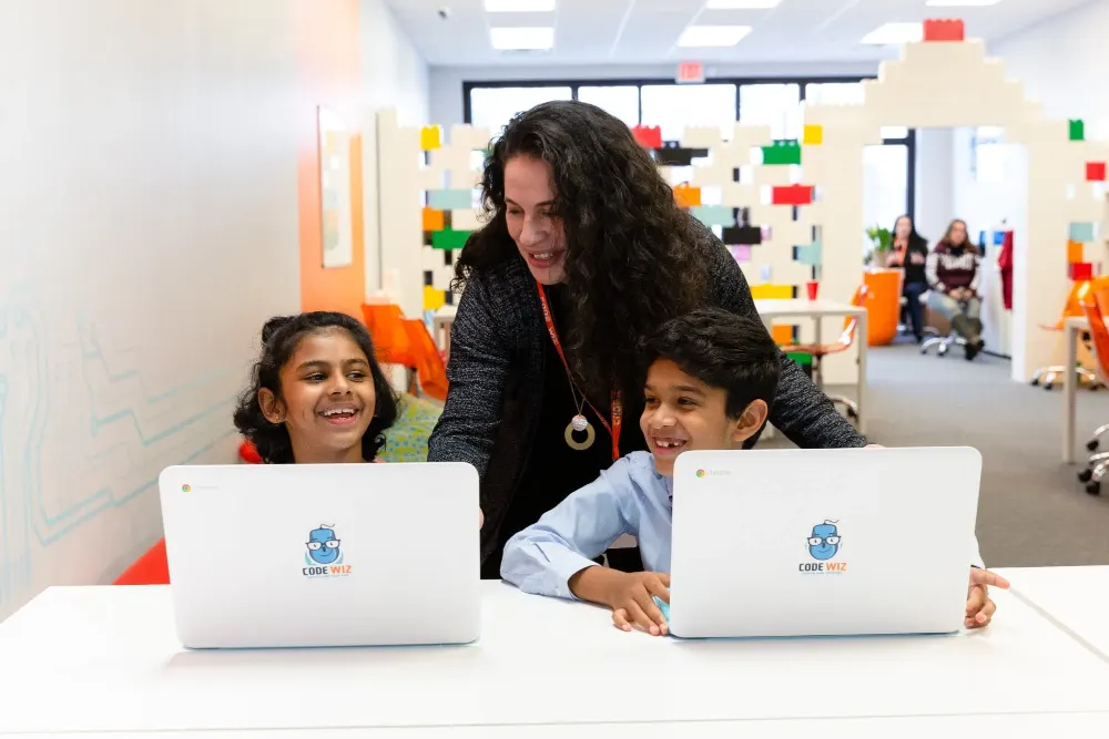 A Code Wiz Edison coach working with a student