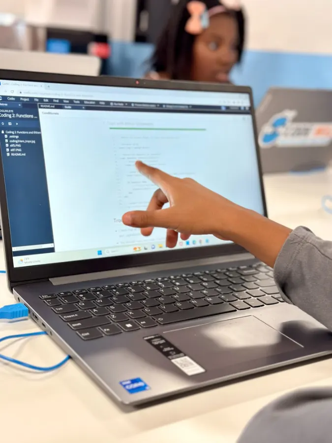 Students coding on laptops